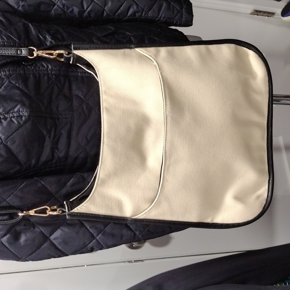 AhDorned cream canvas bag with mini clutch included.